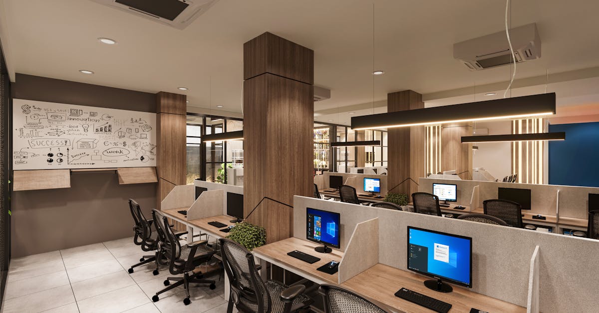 Contemporary open office space with cubicles, computers, and a creative whiteboard wall in a profess