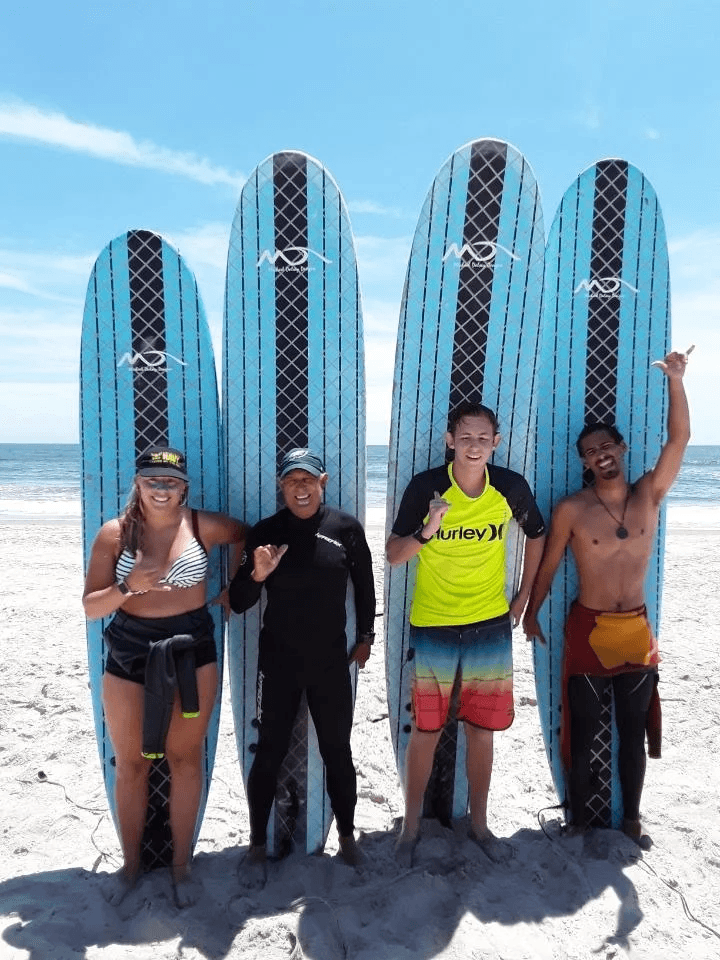 Group of men standing with Sufboard