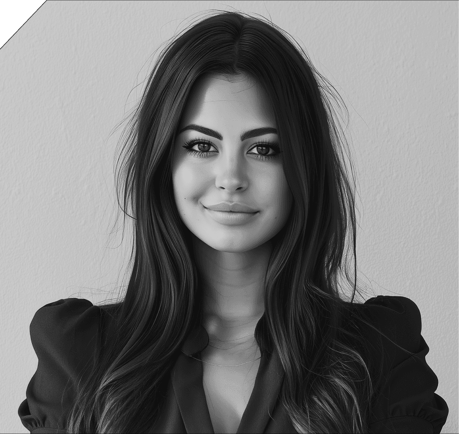 A woman with short curly hair wearing a black t-shirt looks into the camera.