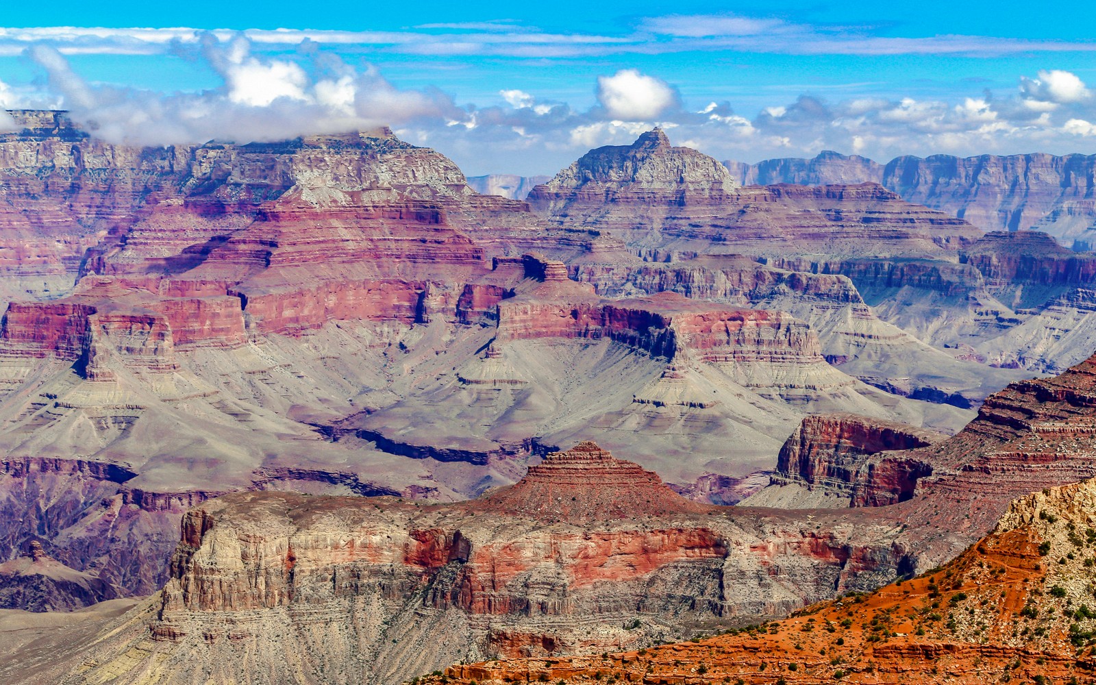 Grand Canyon's layered rock formations under a clear blue sky.