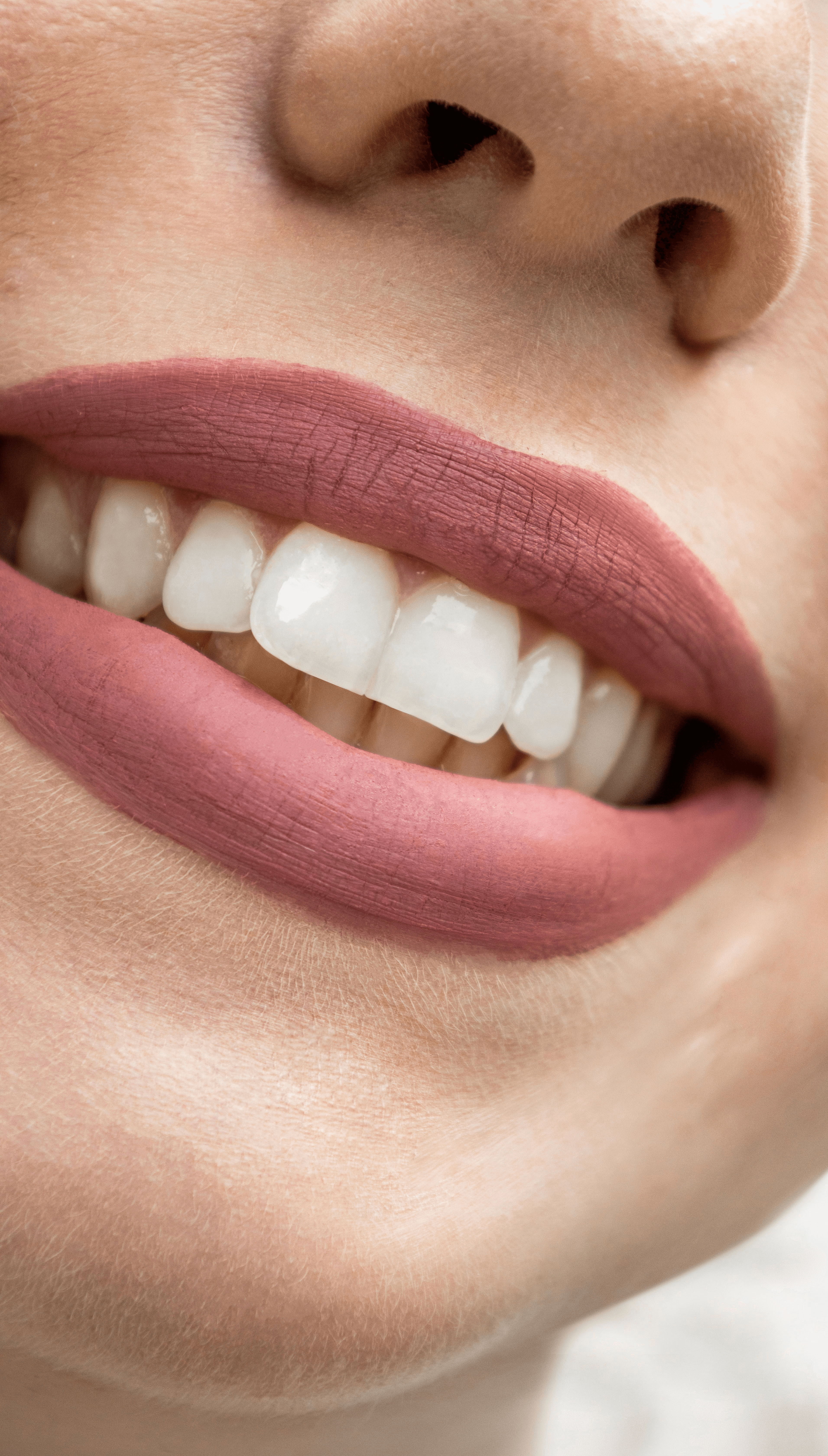 a close up of a woman's mouth with white teeth