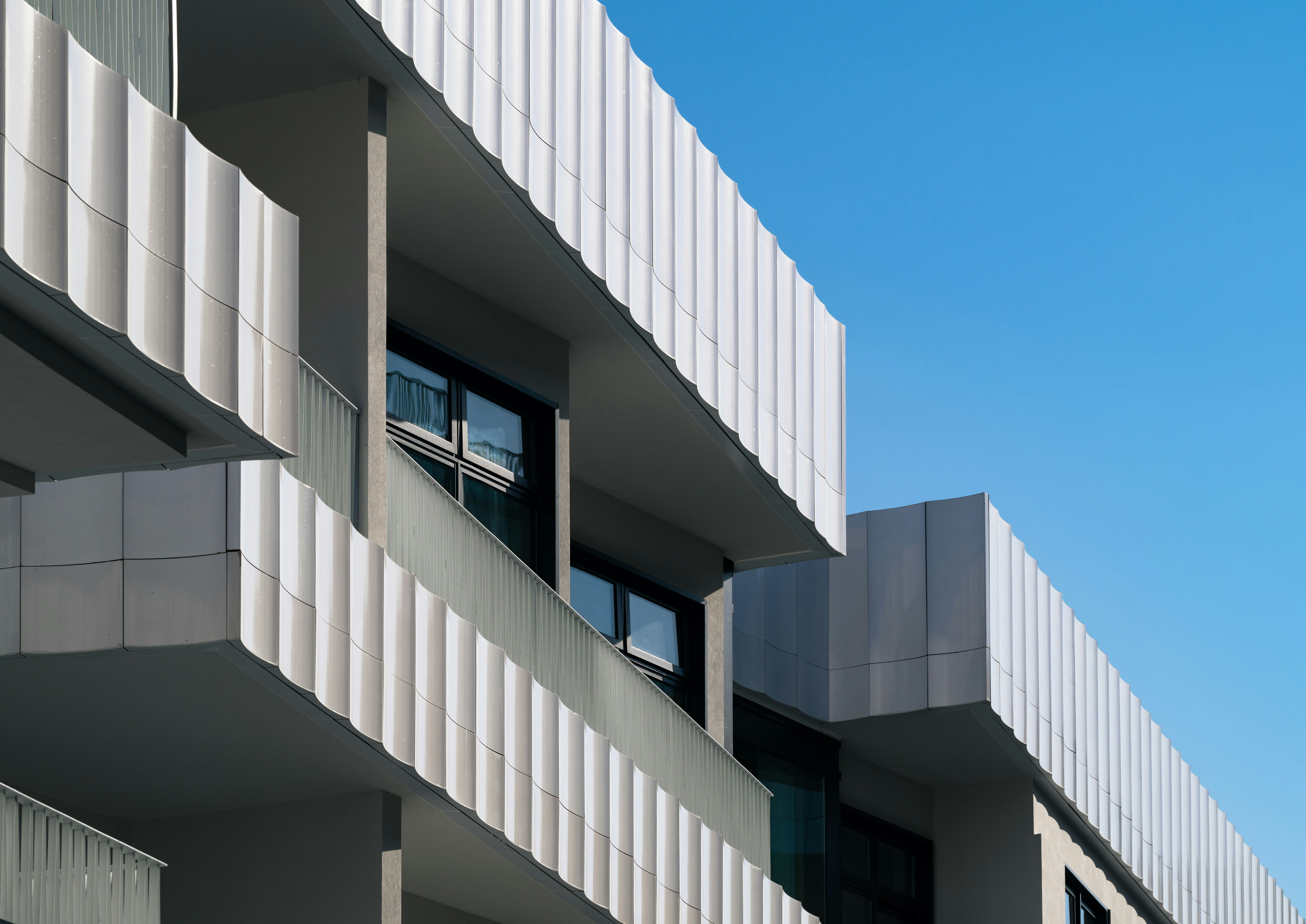 A tall building with balconies on the side of it