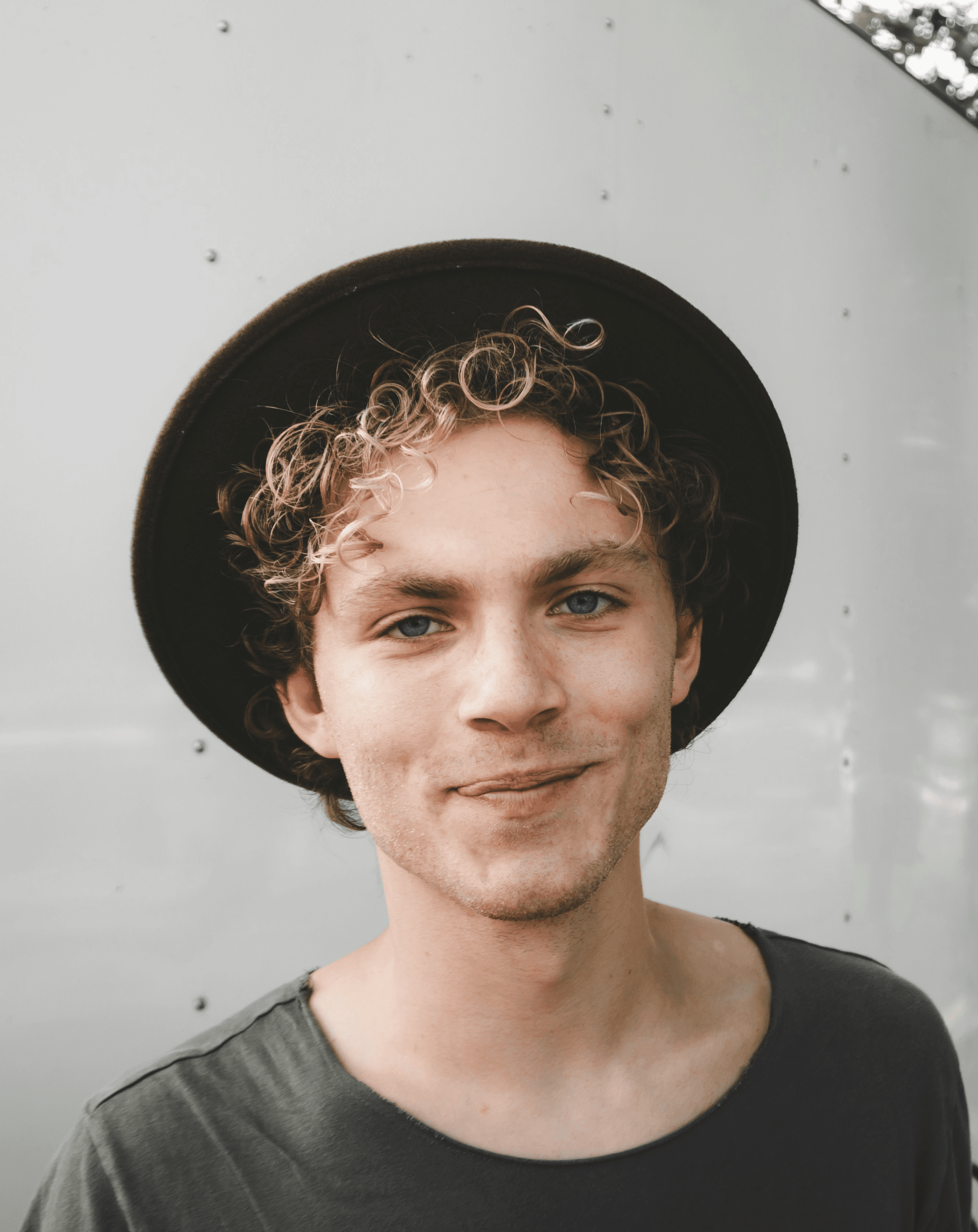 man standing near white wall