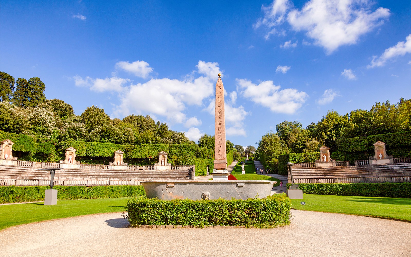 Amphitheater at Boboli Gardens with central obelisk and surrounding greenery in Florence, Italy.