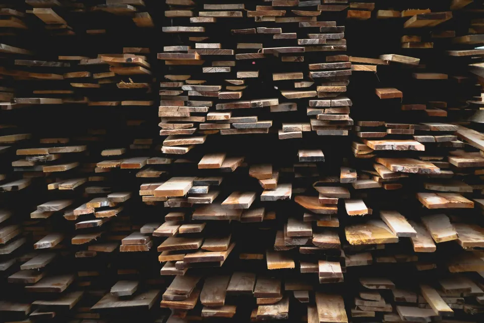 Stacks of timber boards in a dark workshop