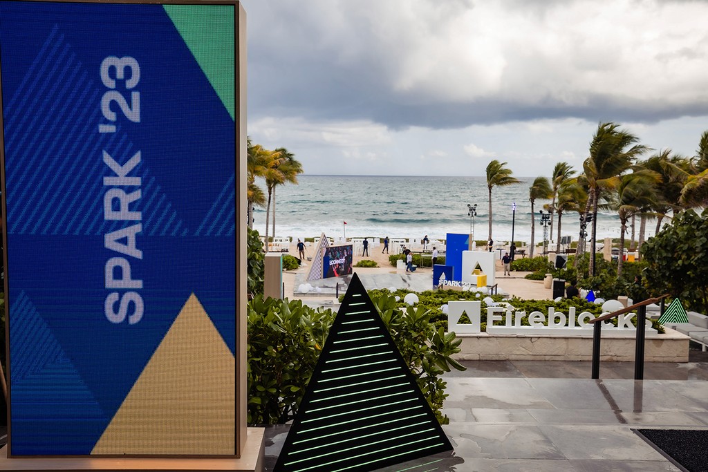 Photo of an outdoor screen and decorations with SPARK branding. 