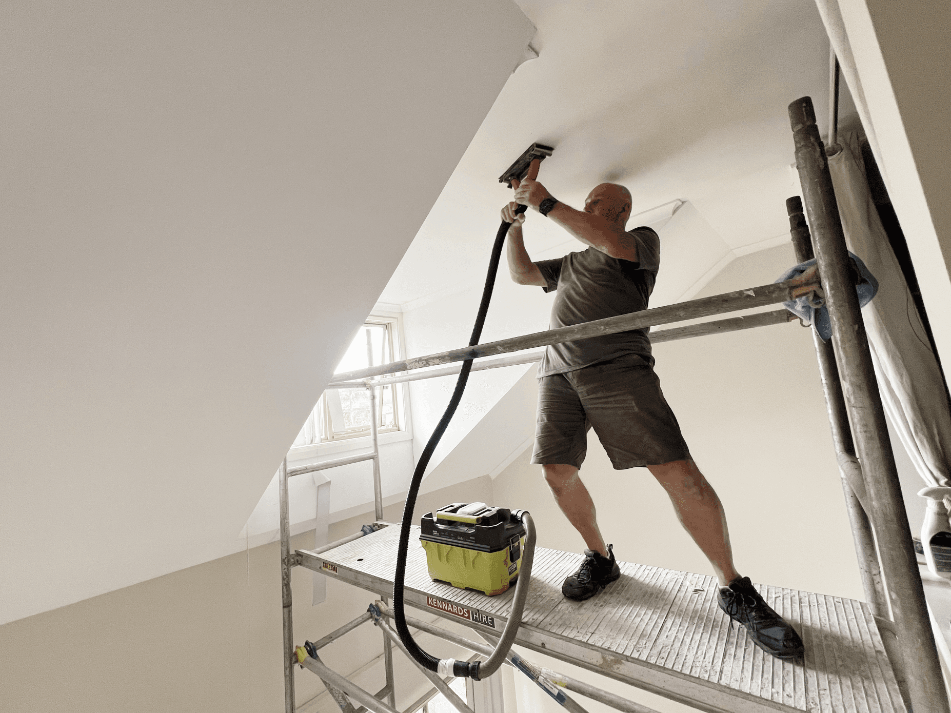 man standing infront of miter saw