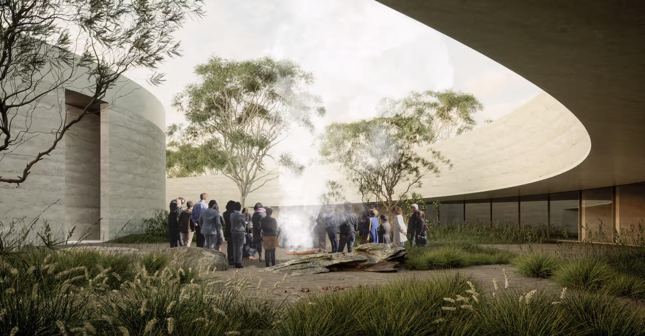 Architectural render of Ngurra, the National Aboriginal and Torres Strait Islander Cultural Precinct, with people gathered around a smoking ceremony in a curved sandstone courtyard planted with native grasses