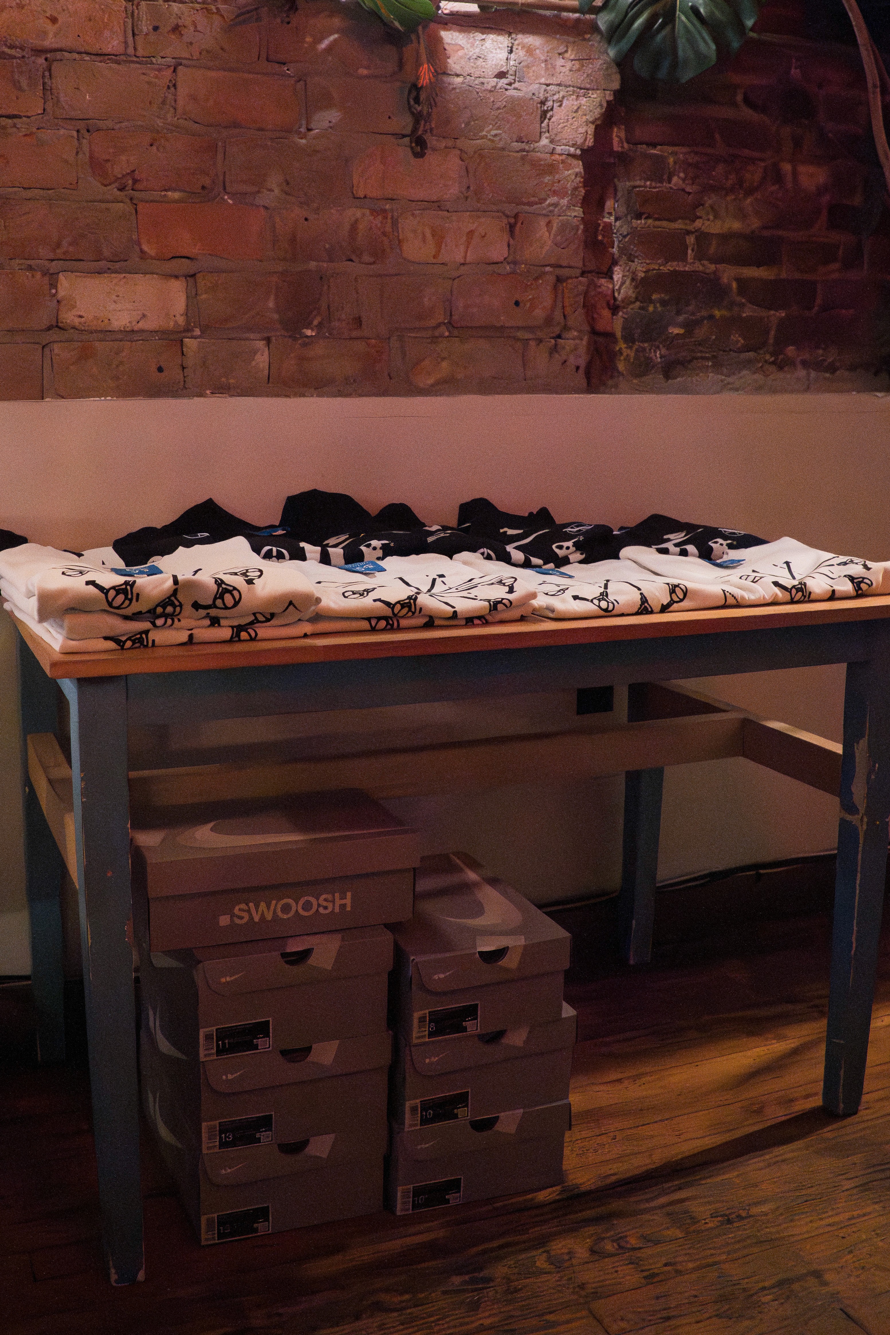 Event table setup with Nike boxes and merch during an EXP.Pack-hosted 007 tournament.