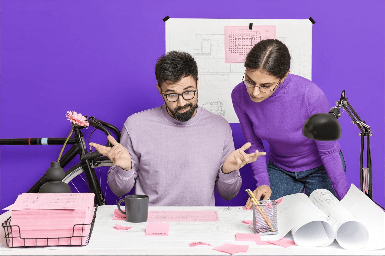 Man in suit interviews woman holding clipboard.