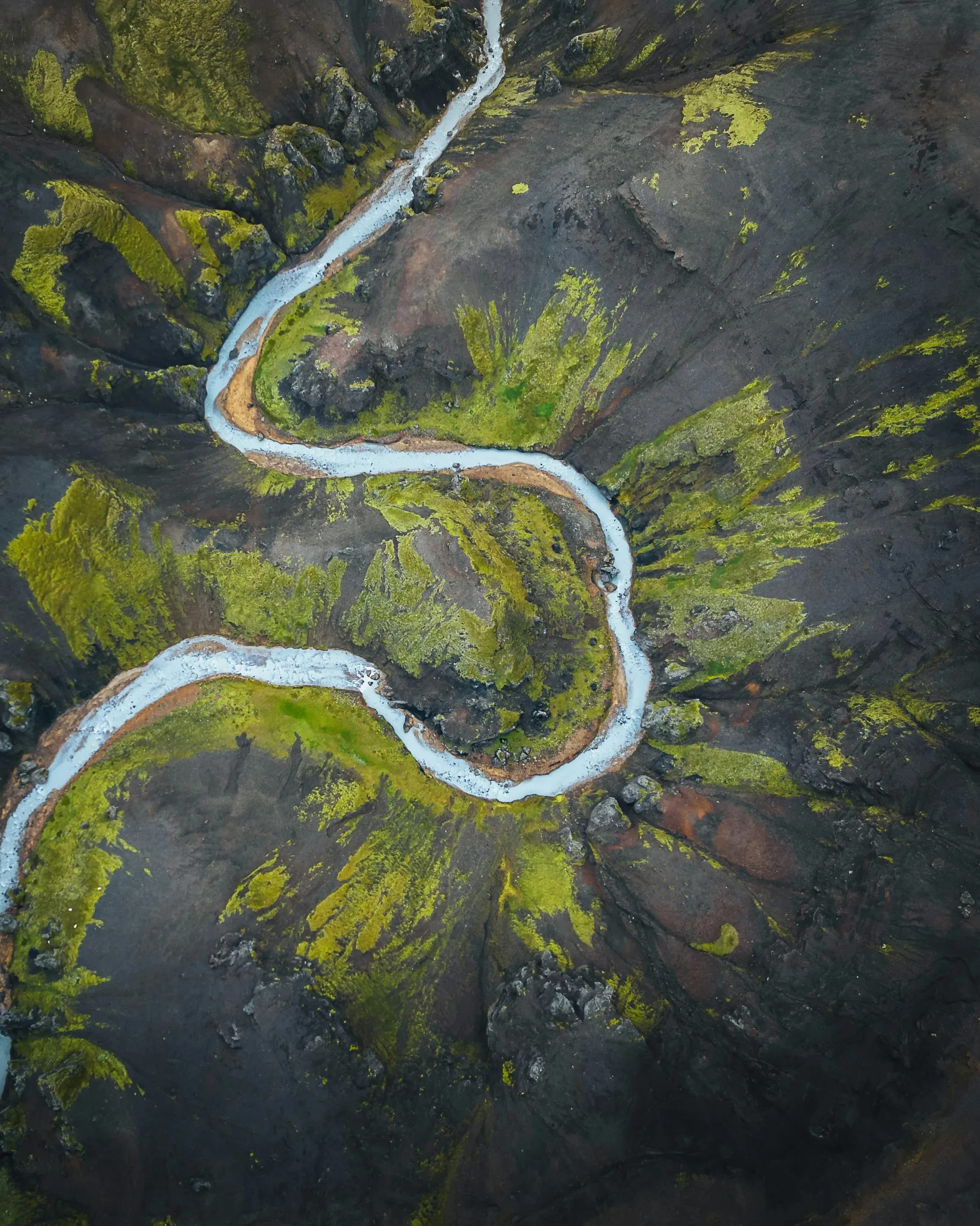 a river running through a lush green valley