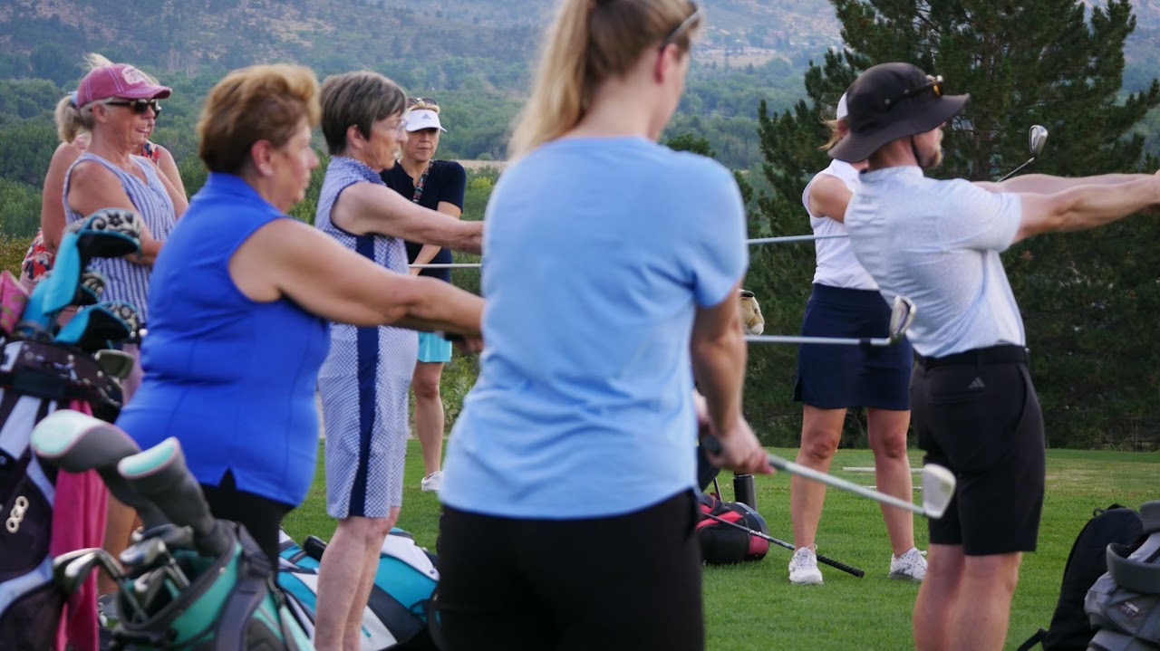 A group of older female students following along to Jack's demonstration.