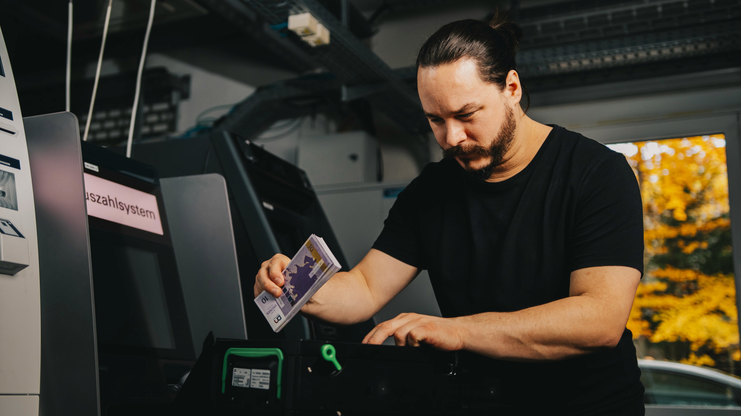 SBS employee refilling an ATM, ensuring accurate cash levels for continuous operation and optimized cash flow management.