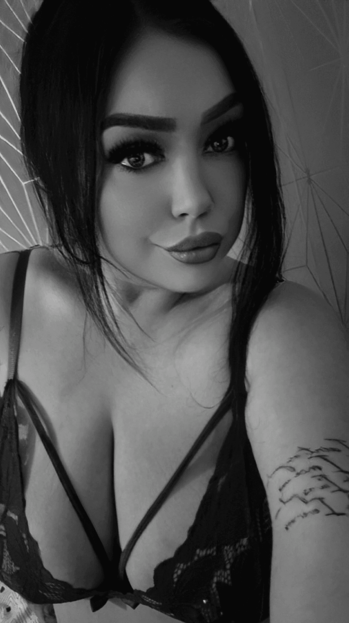 Woman in black lace lingerie with garter straps.