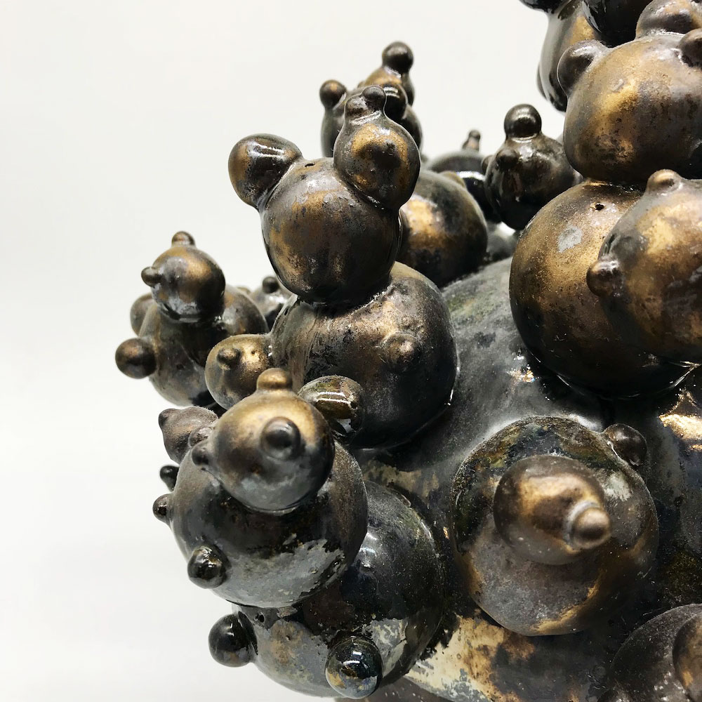 Two people doing a side stretch pose on yoga mats