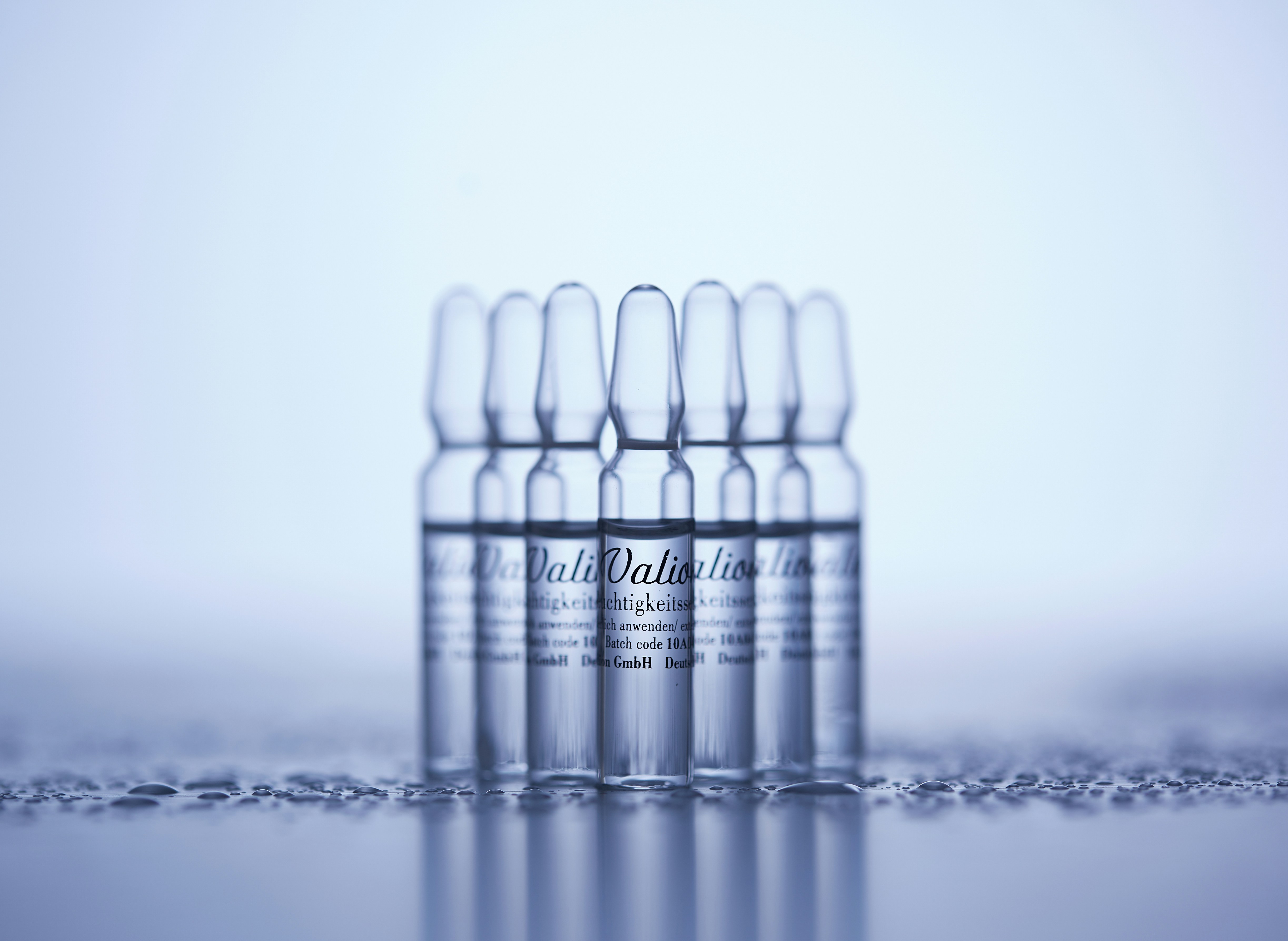 a row of clear bottles sitting on top of a table