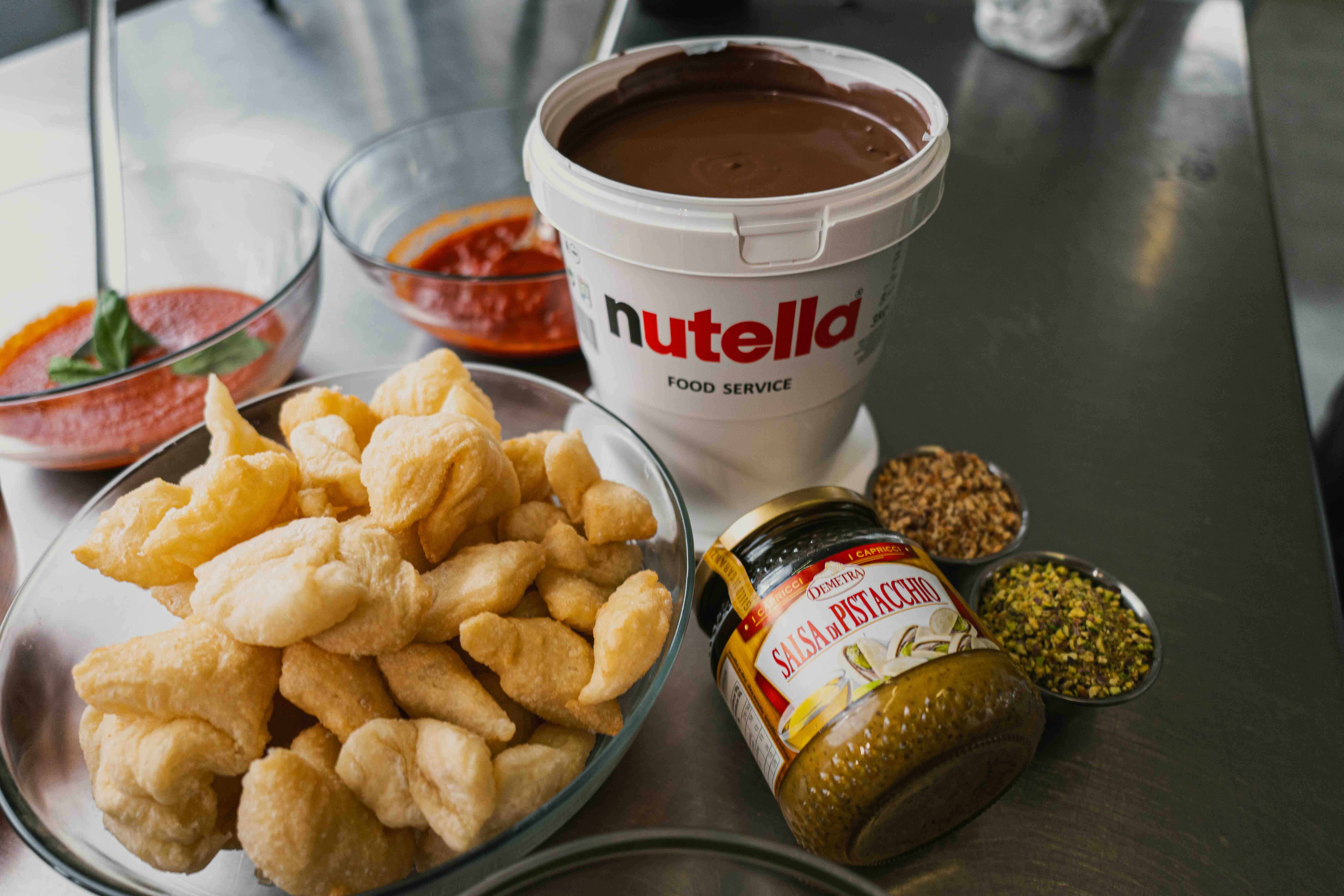 Smiling barista holding green cup at coffee machine