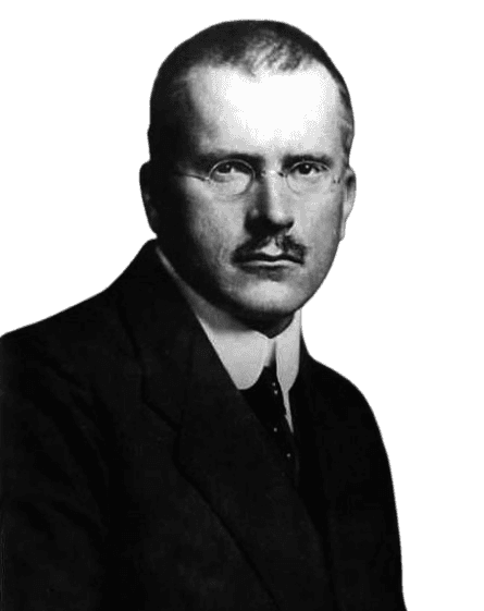 A black-and-white portrait of a serious-looking man with a neatly trimmed mustache, wearing round glasses and a dark suit with a white shirt and tie. The subject, shown from the chest up, has short, neatly combed hair and gazes directly at the camera. The dark background adds emphasis to the man's formal attire and composed expression, creating a classic, timeless image.