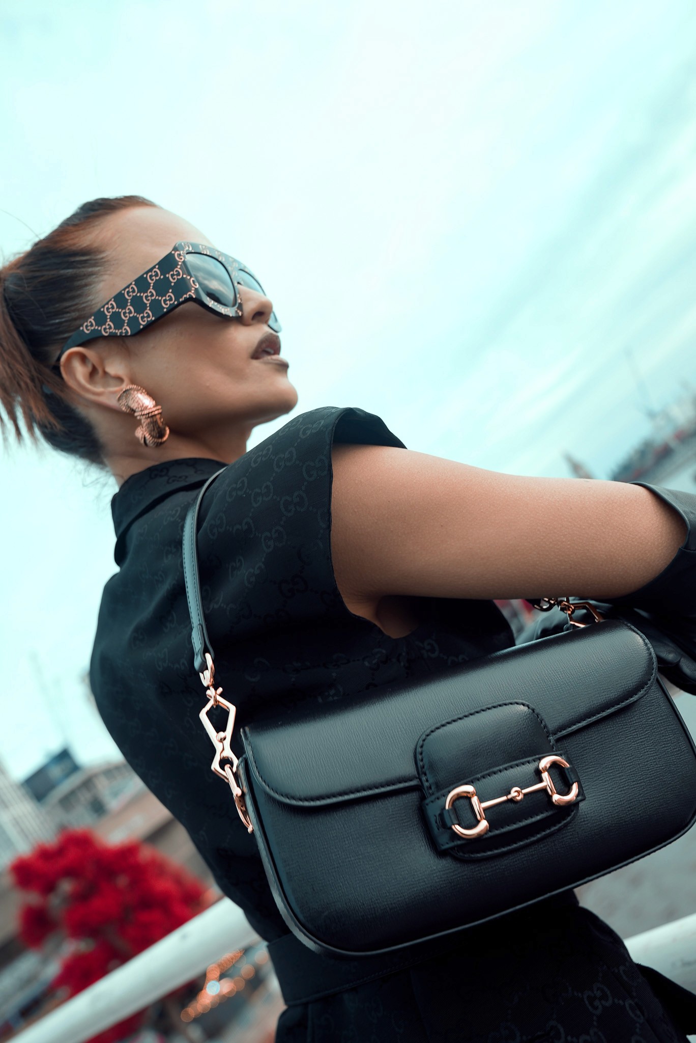 Tree branches against white house and fence