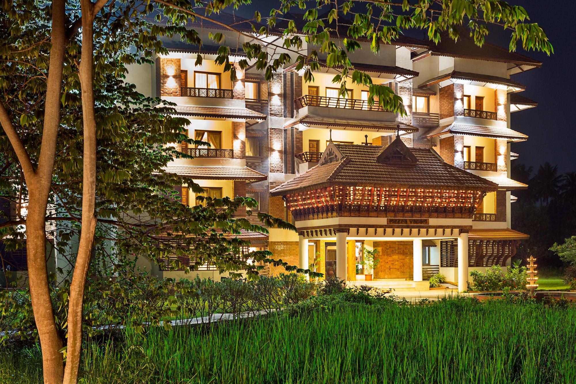 Aerial view of a winding road cutting through rocky terrain with patches of grass.