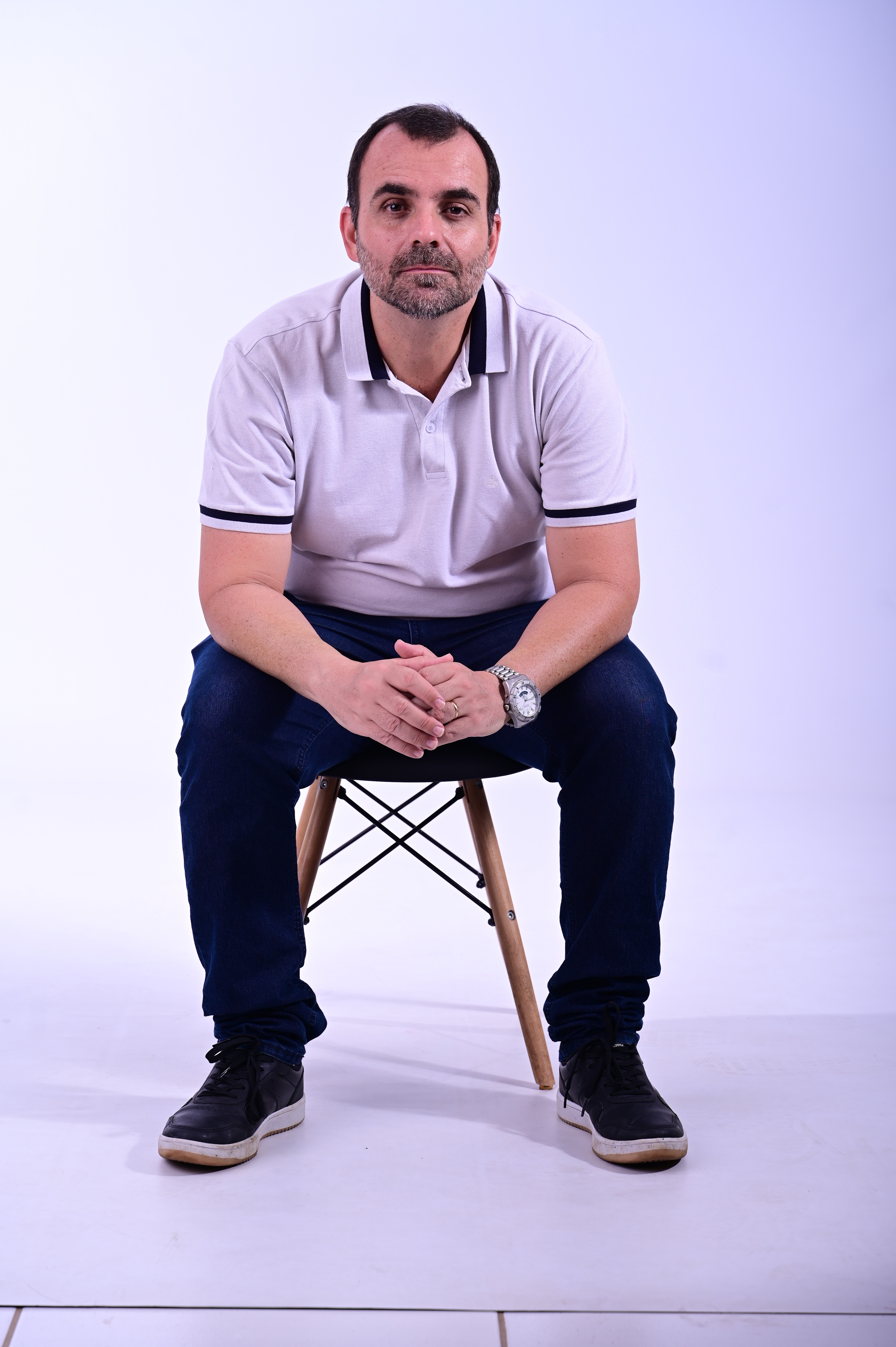 a man with a goatee smiles at the camera