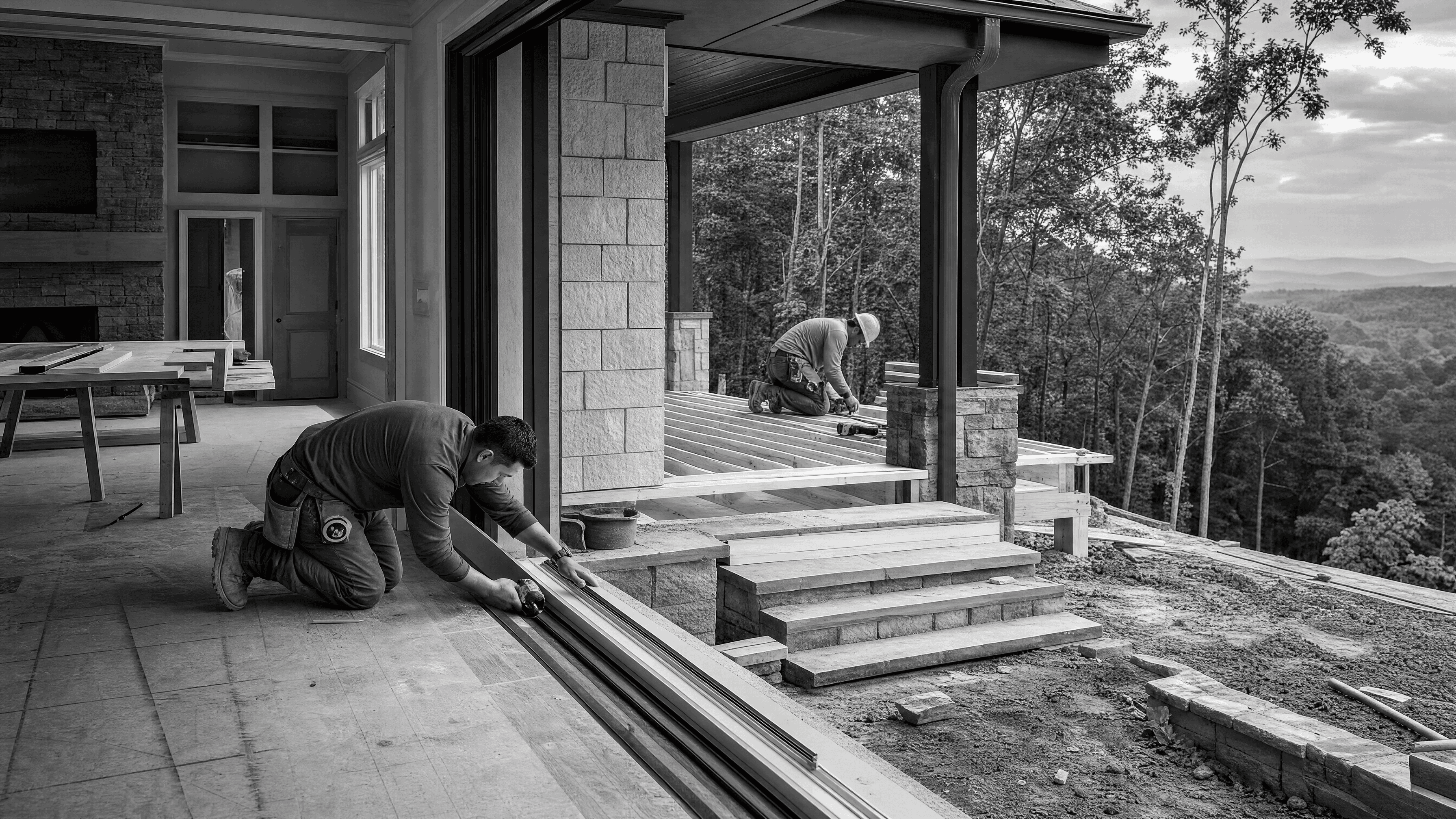 Active renovation connecting an interior opening to exterior deck construction on a wooded hillside property.