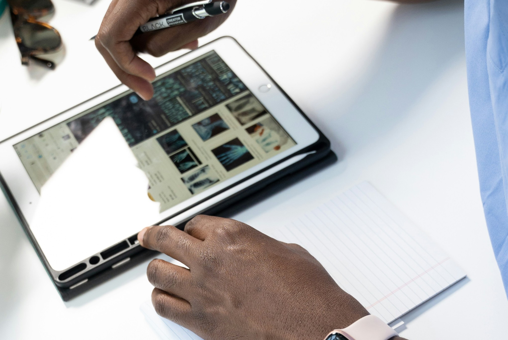 Close-up of a healthcare professional reviewing digital records on a tablet, representing technology's role in optimizing the healthcare revenue cycle.