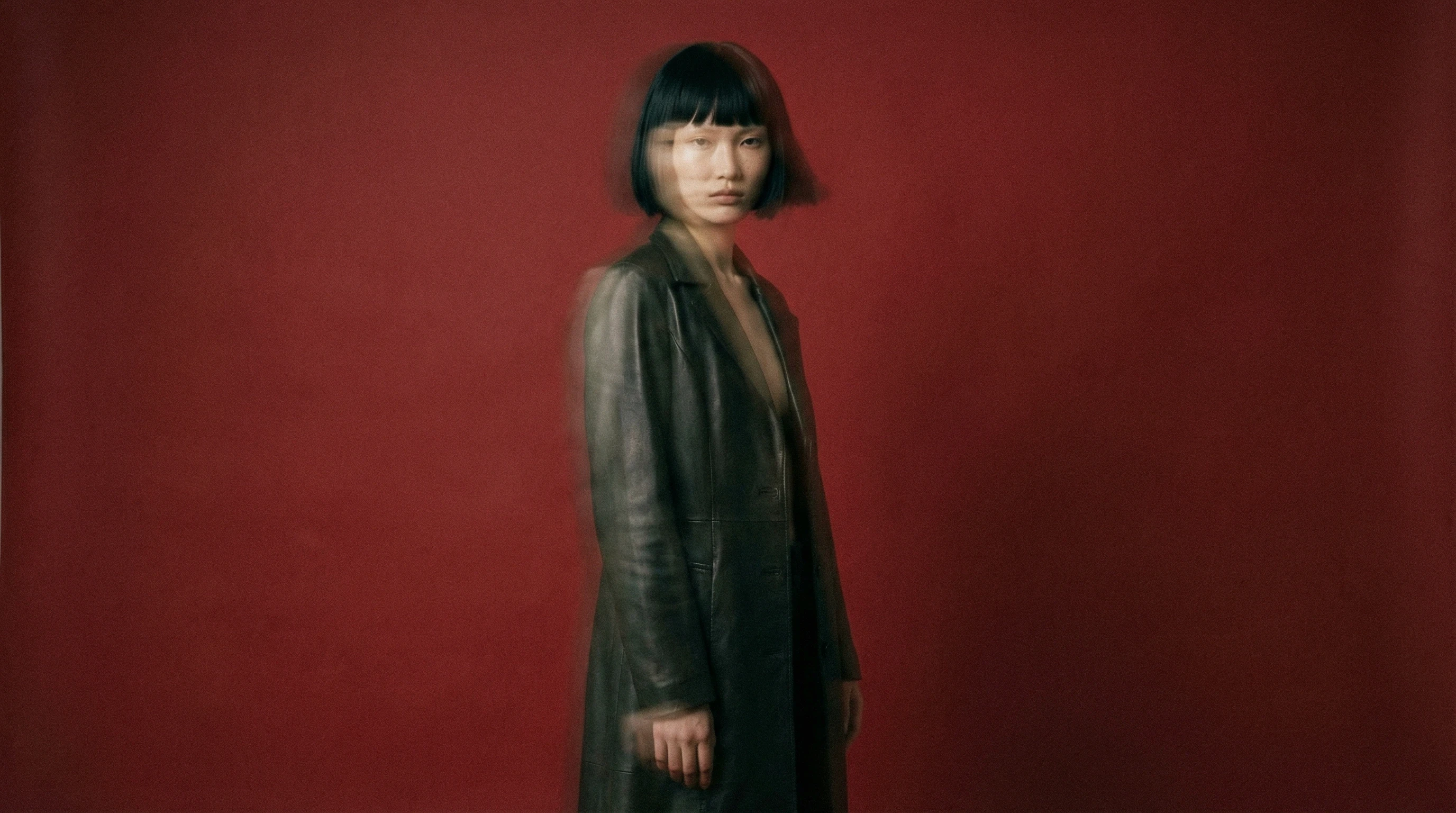 Woman in front of a red background