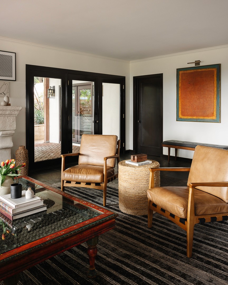 This contemporary living room features a cozy, airy atmosphere with a custom linen sofa and earthy wooden accents