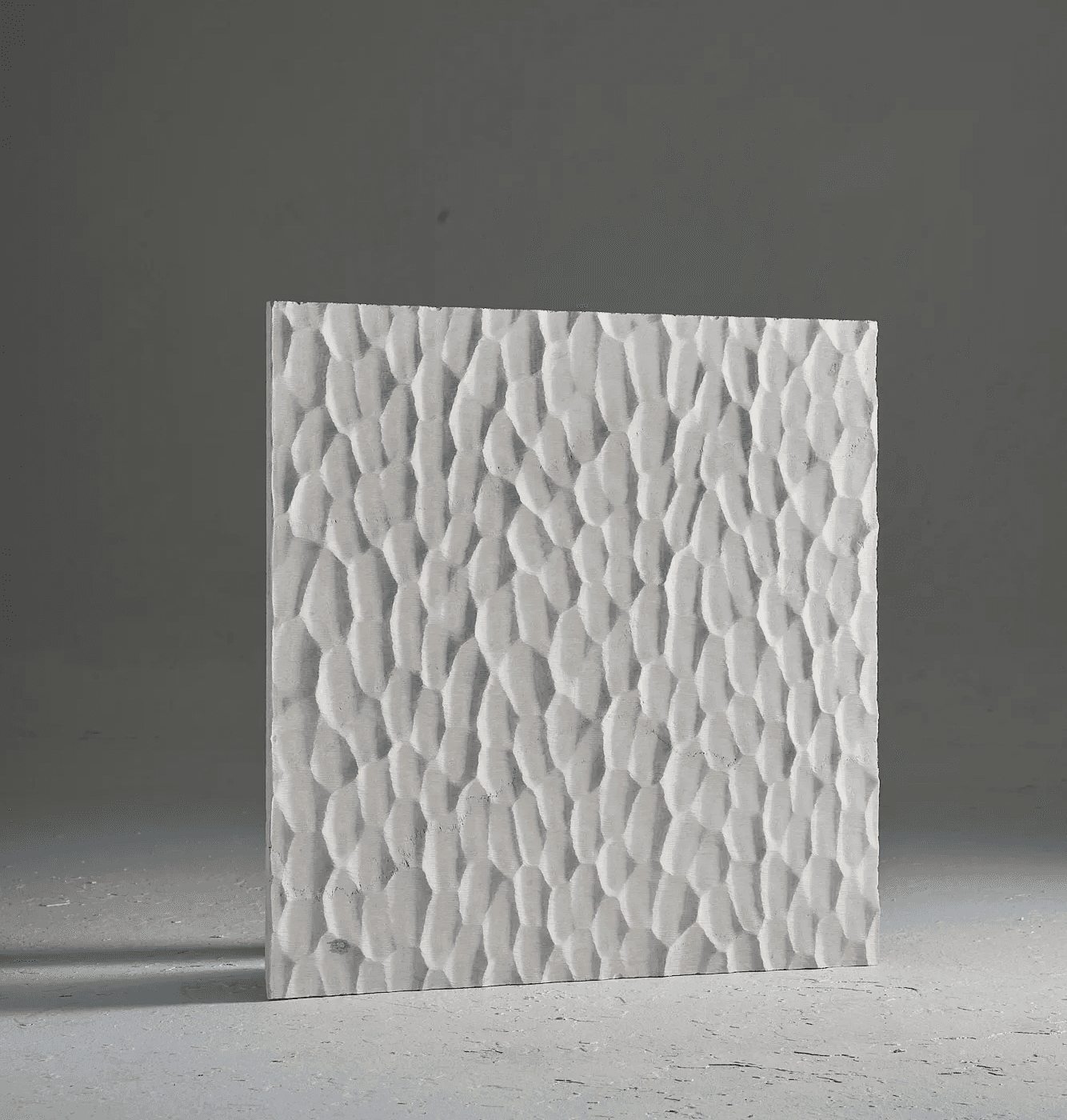 Carved marble surface study inspired by Japanese Naguri woodworking, featuring rhythmic chisel-like marks and repeated relief patterns.