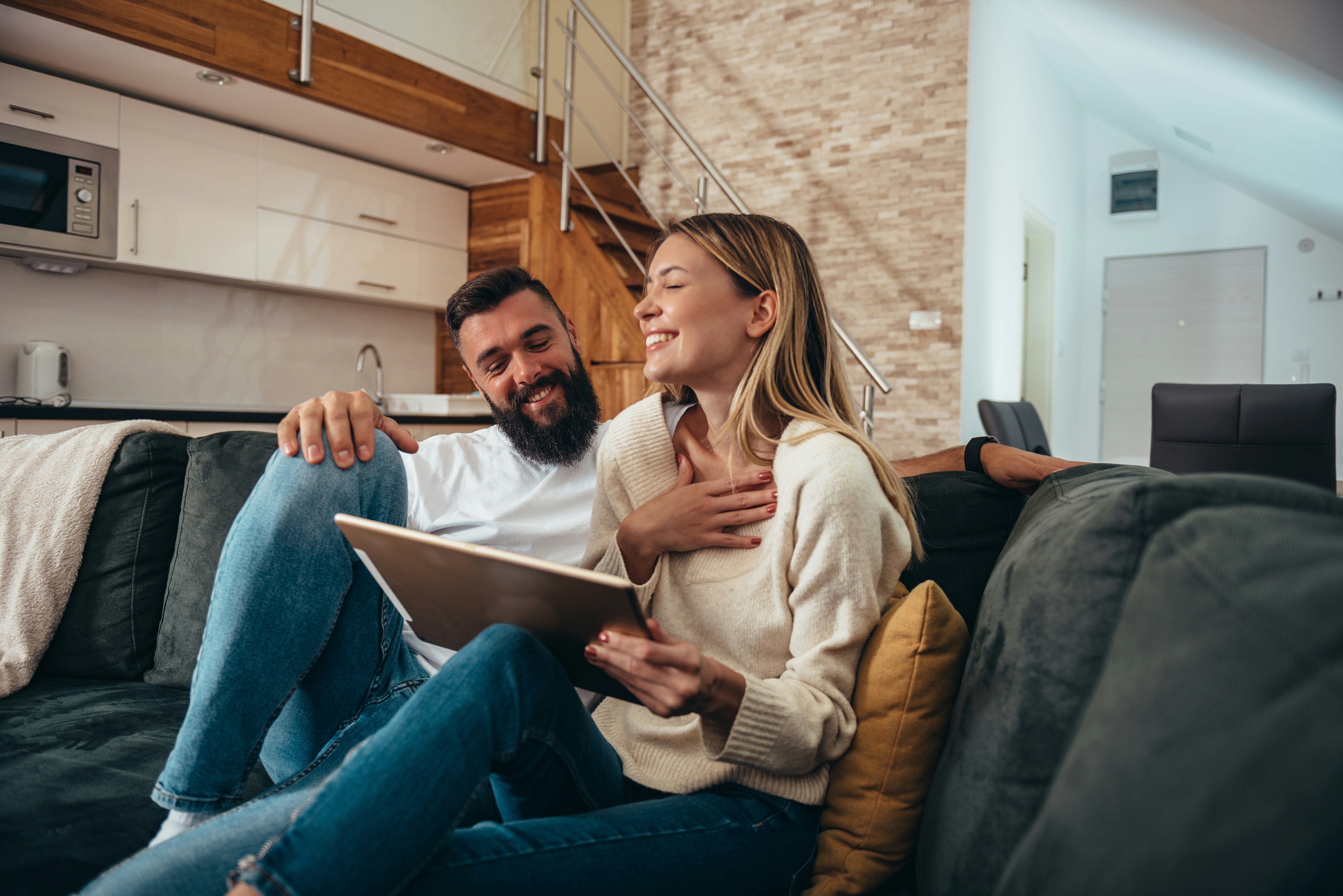 happy couple looking at computer