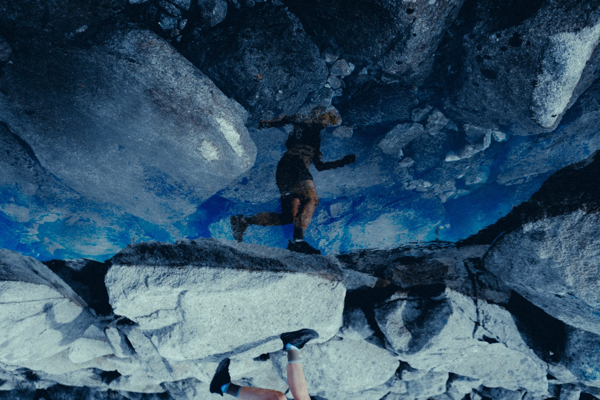 refelction of woman, running, in water.