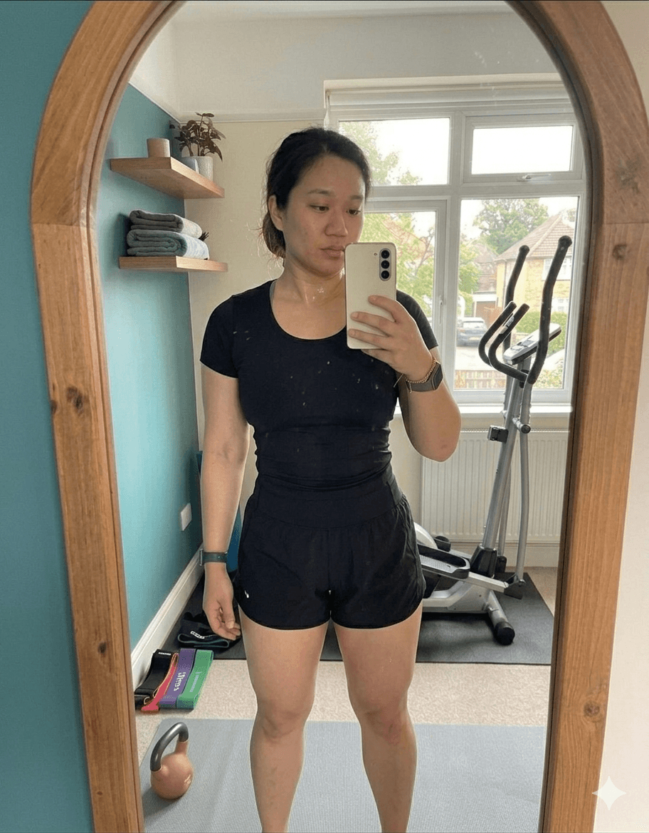 Amelia after fitness transformation – front view mirror selfie showing slimmer toned physique in grey workout set