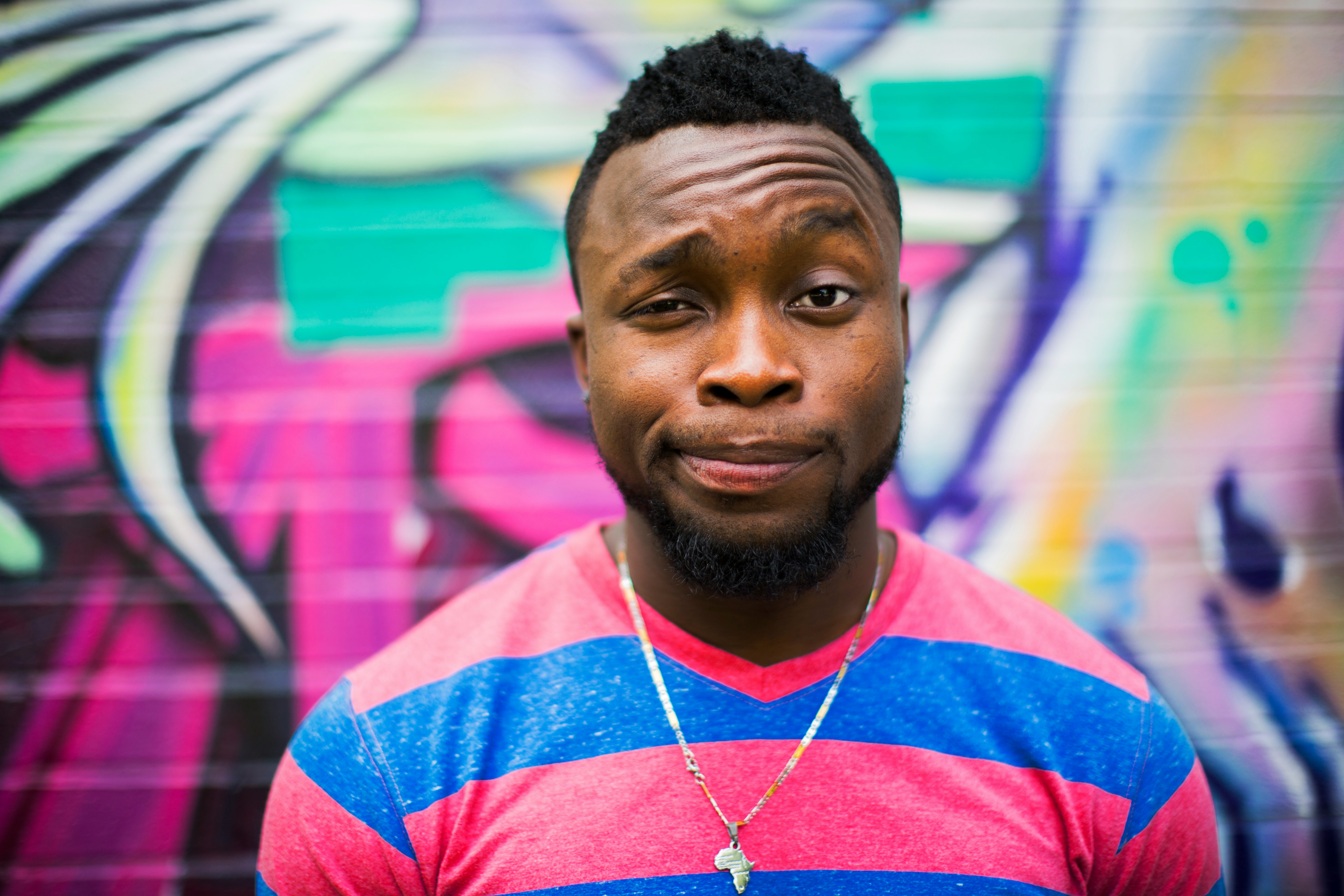 man with colorful background - Mid Taper Fade