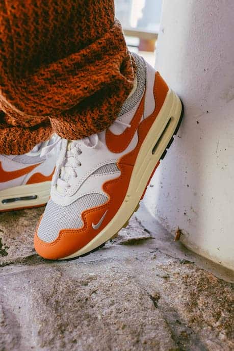 Close-up of an orange and white Nike Air Max 1 sneaker, from the Patta section on Shopify