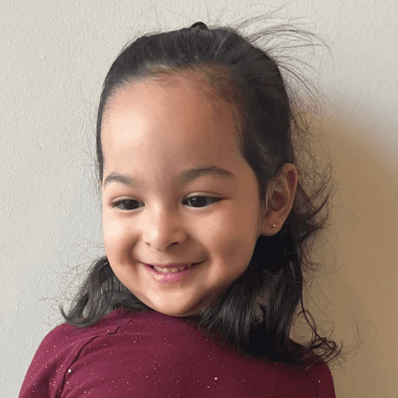 A headshot of a smiling client against an office wall.