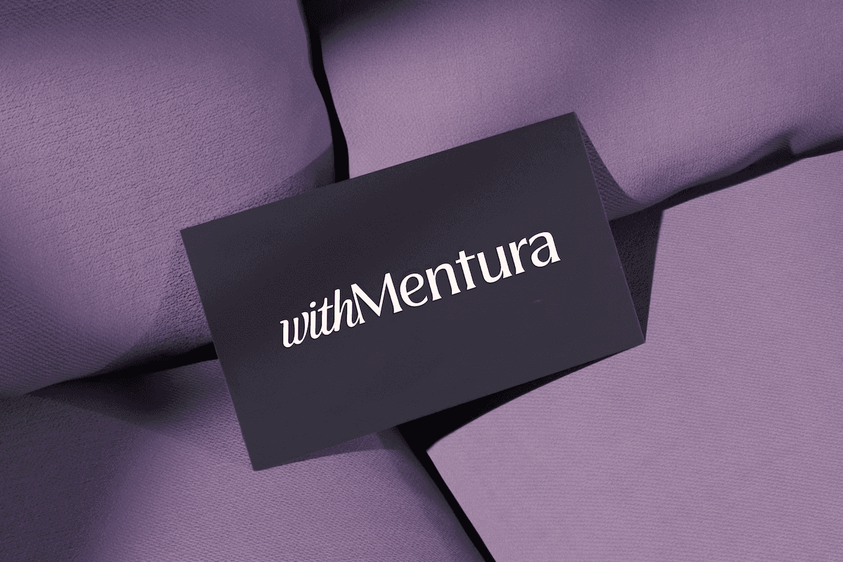 With Mentura brand identity — custom monogram crest, serif typography and plum and cream palette by Tigera