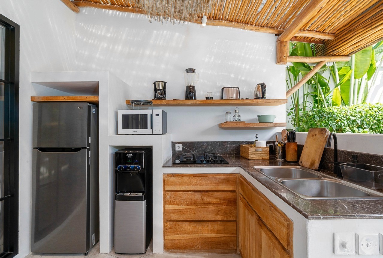 Fully equipped modern kitchen in a Bali villa. Premium property listings and agent services at Nyanyi Beach.