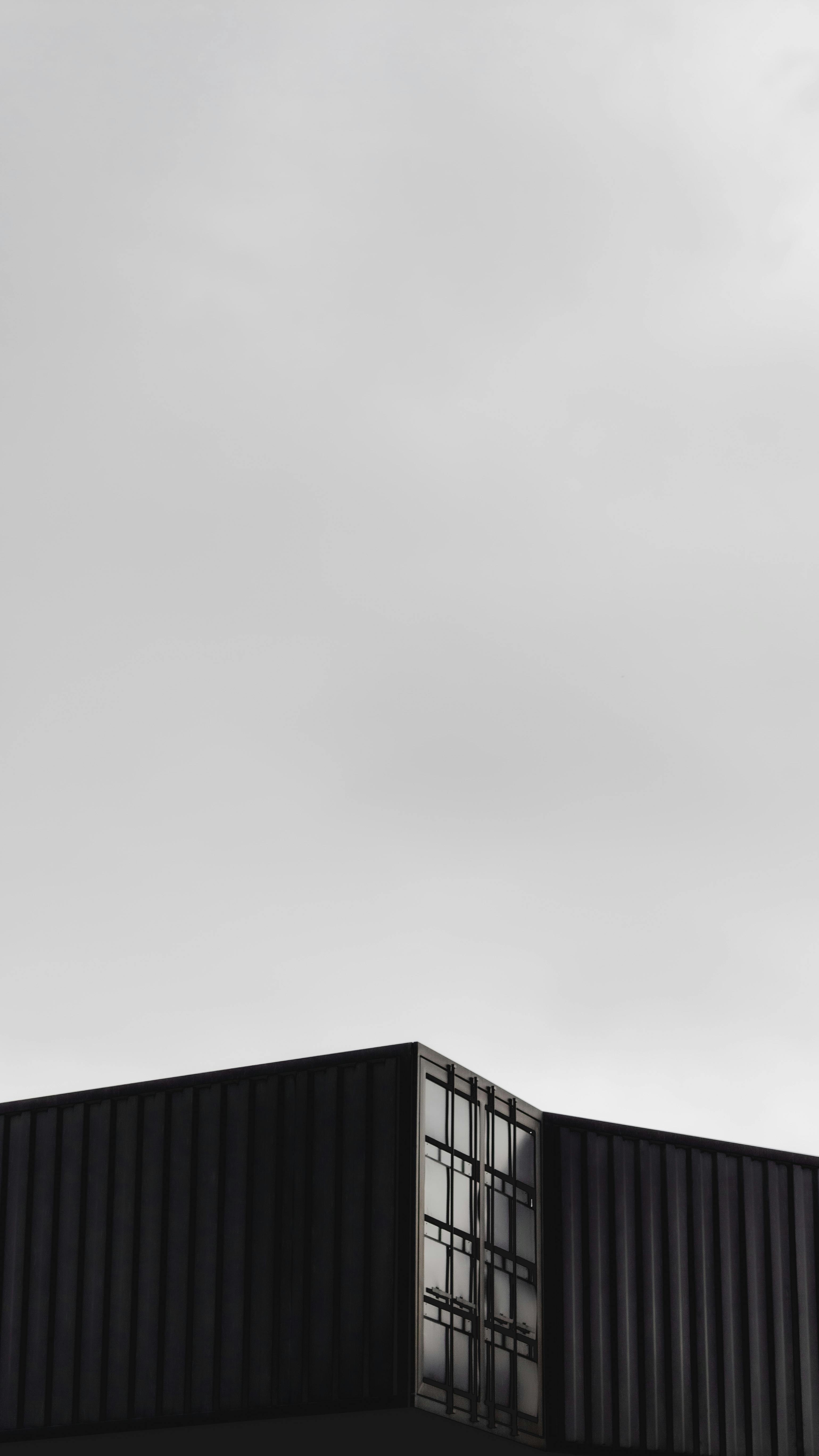 Dark themed containers with sky view.