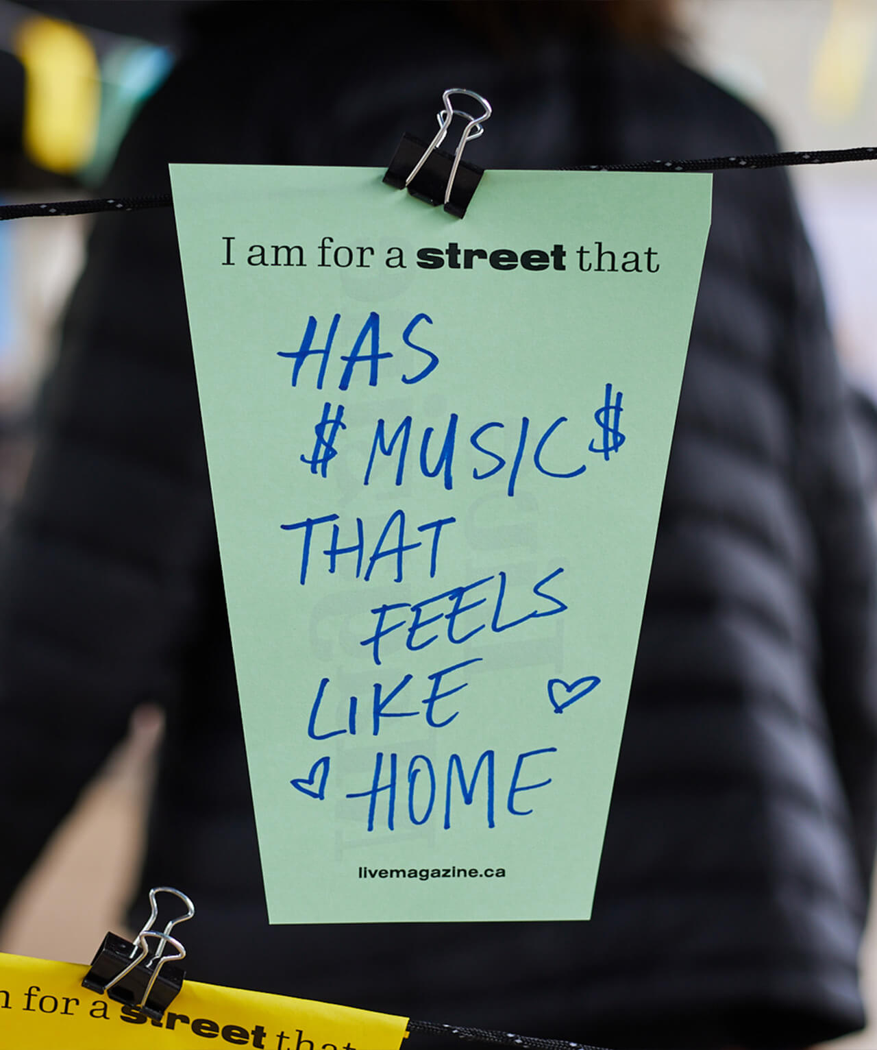 A worksheet with hand-written writing that reads "I am for a street that has music that feels like home."