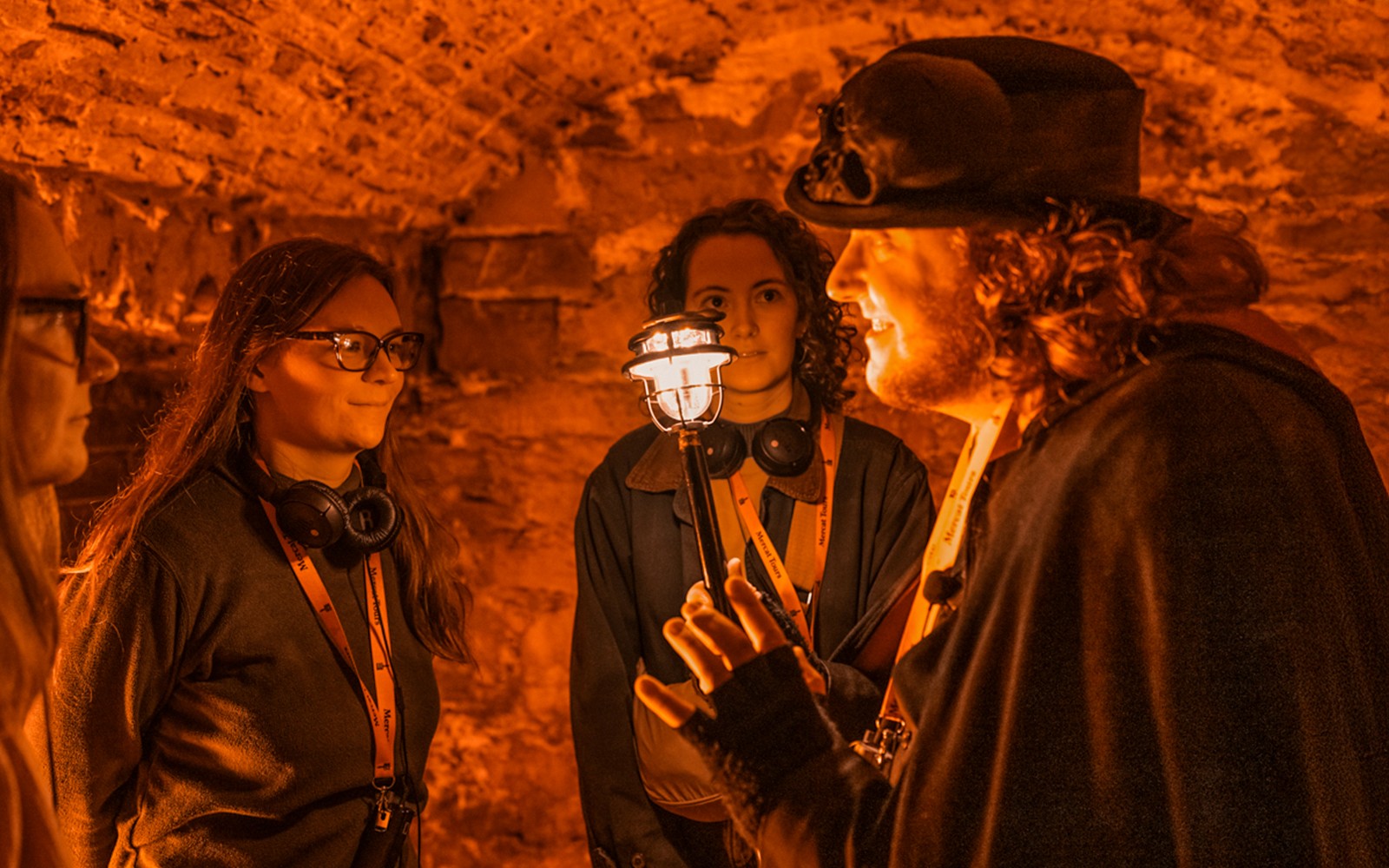 Blair Street Underground guided tour with costumed guide narrating ghost stories in dimly lit Edinburgh vaults.