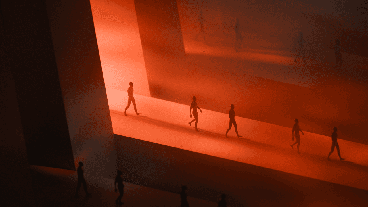 Silhouettes of people walking down a dimly lit, orange-lit corridor.