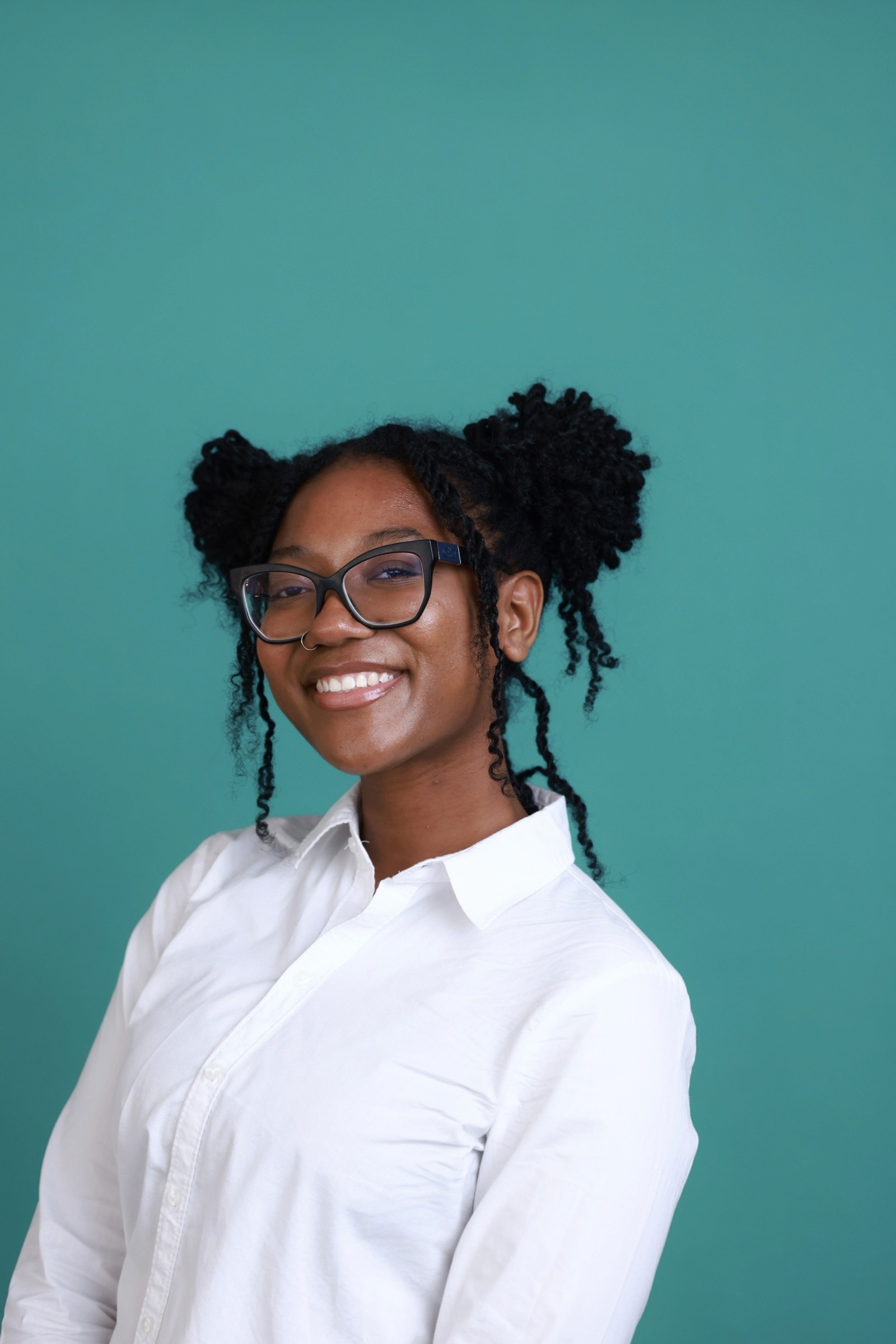 Tree branches reach towards a clear, blue sky.