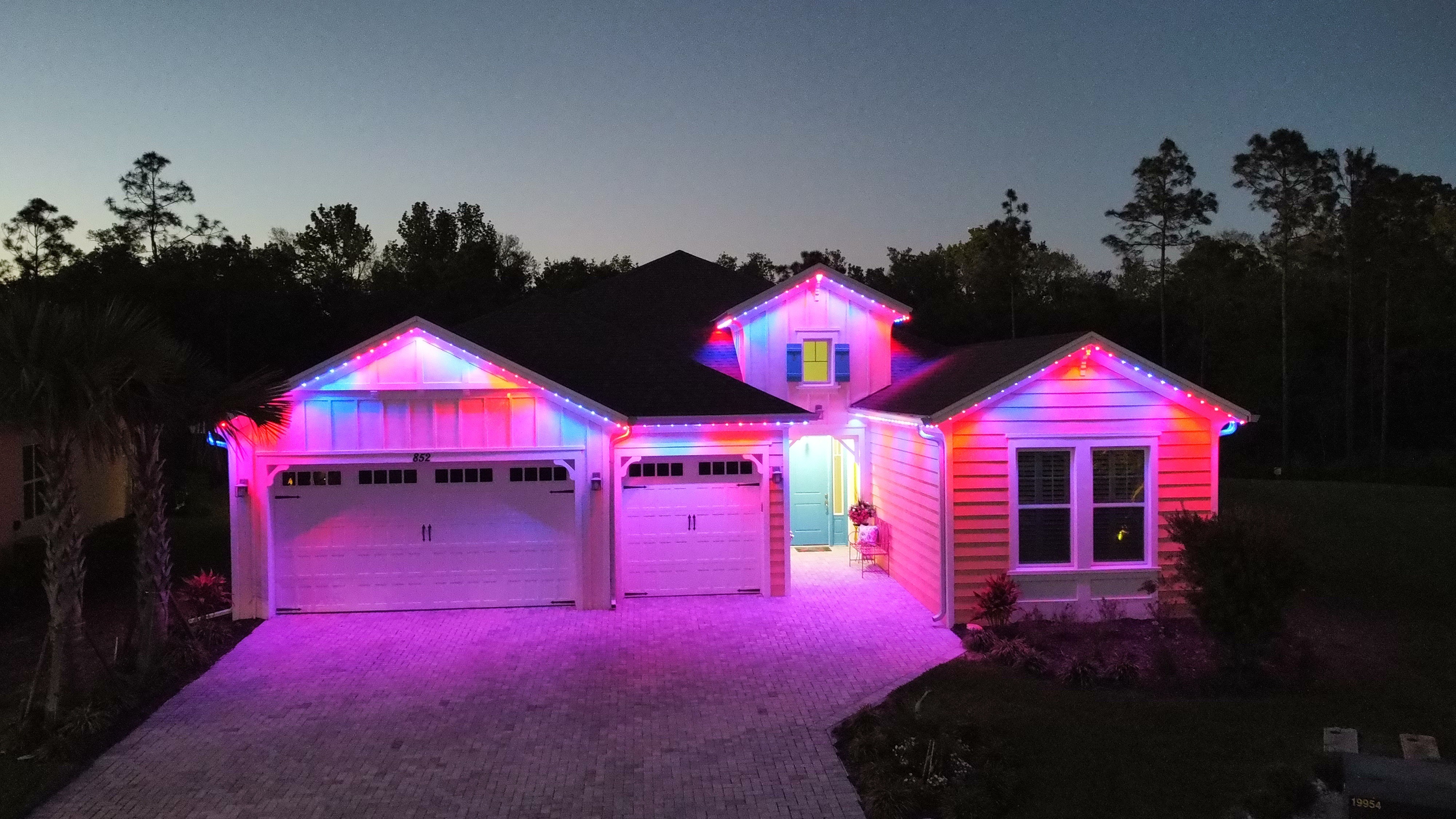 Holiday color permanent lighting installed on residential home facade