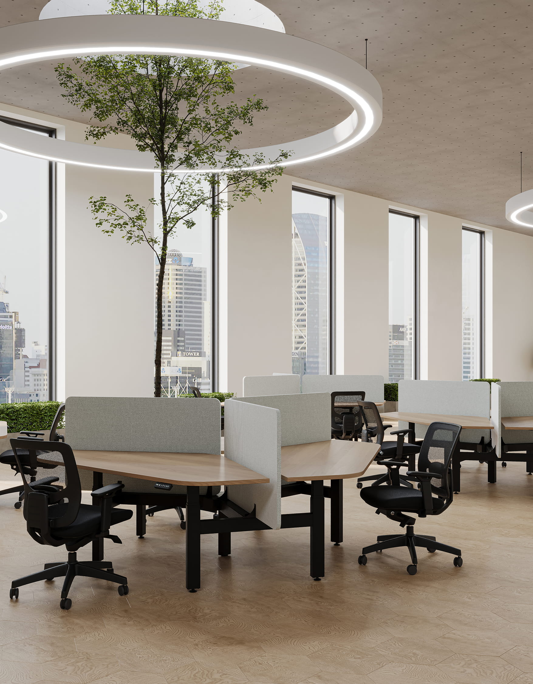 Modern office workspace with desks, chairs, and large windows in natural light