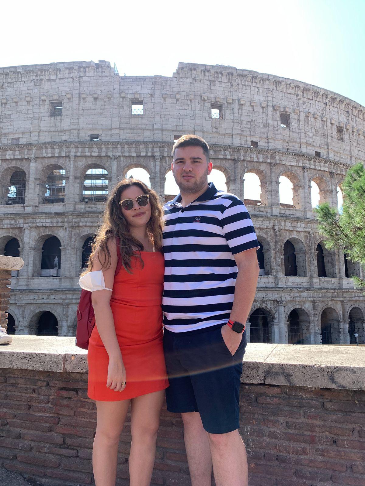 Close-up of two hands gently clasped, one wearing a sparkling engagement ring. The soft lighting and pastel nails evoke a sense of romance and intimacy.