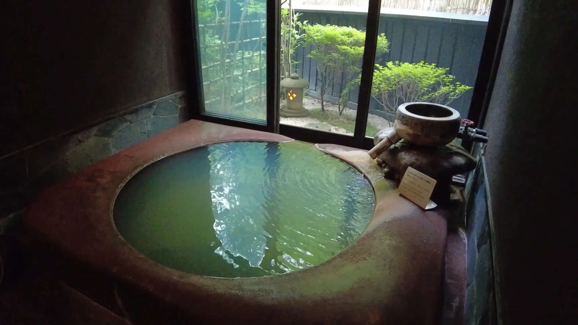 A small round private tub bath at a Kurokawa ryokan