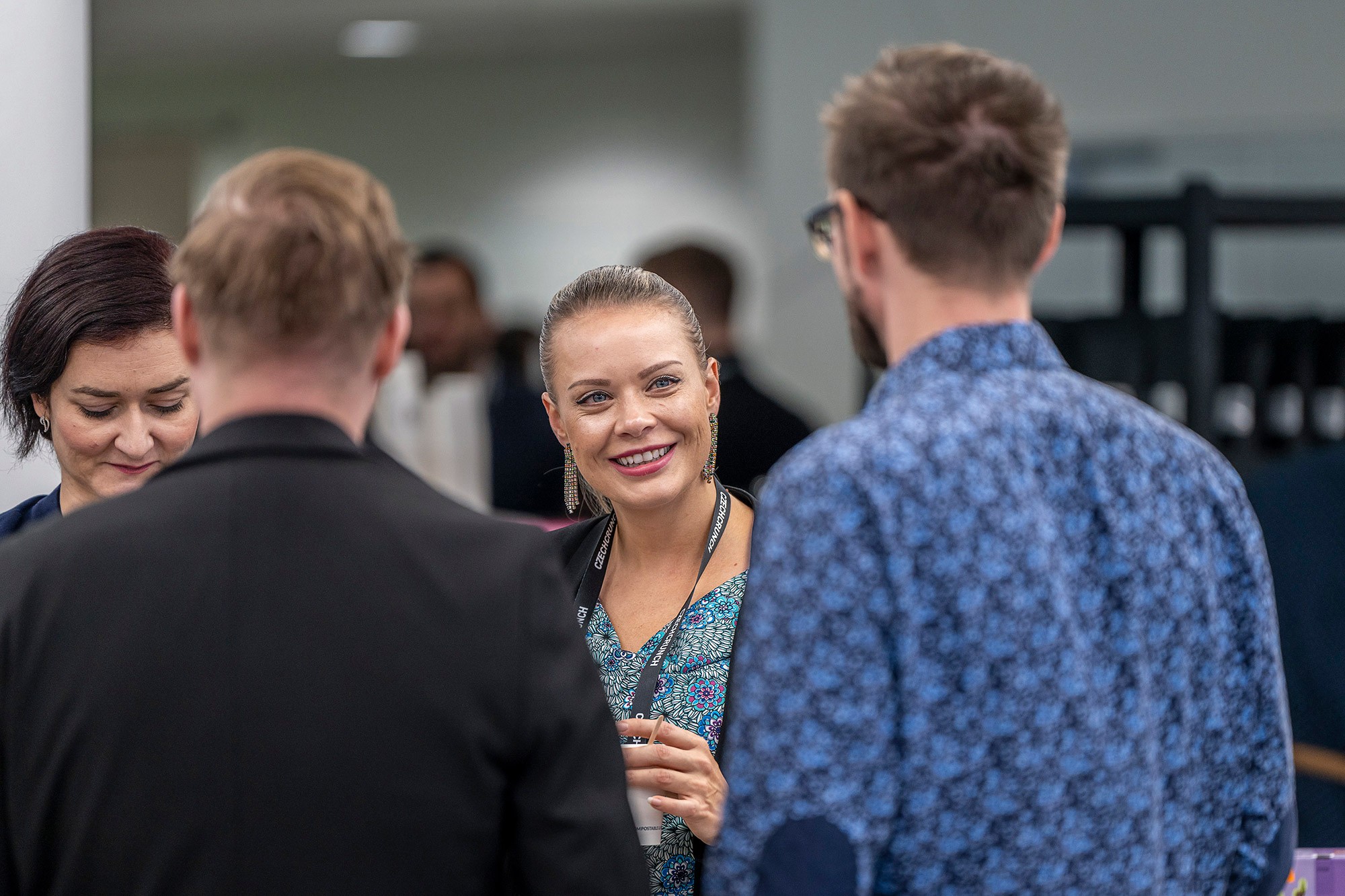 Attendees networking and discussing business topics during Money Maker conference by CzechCrunch in Prague