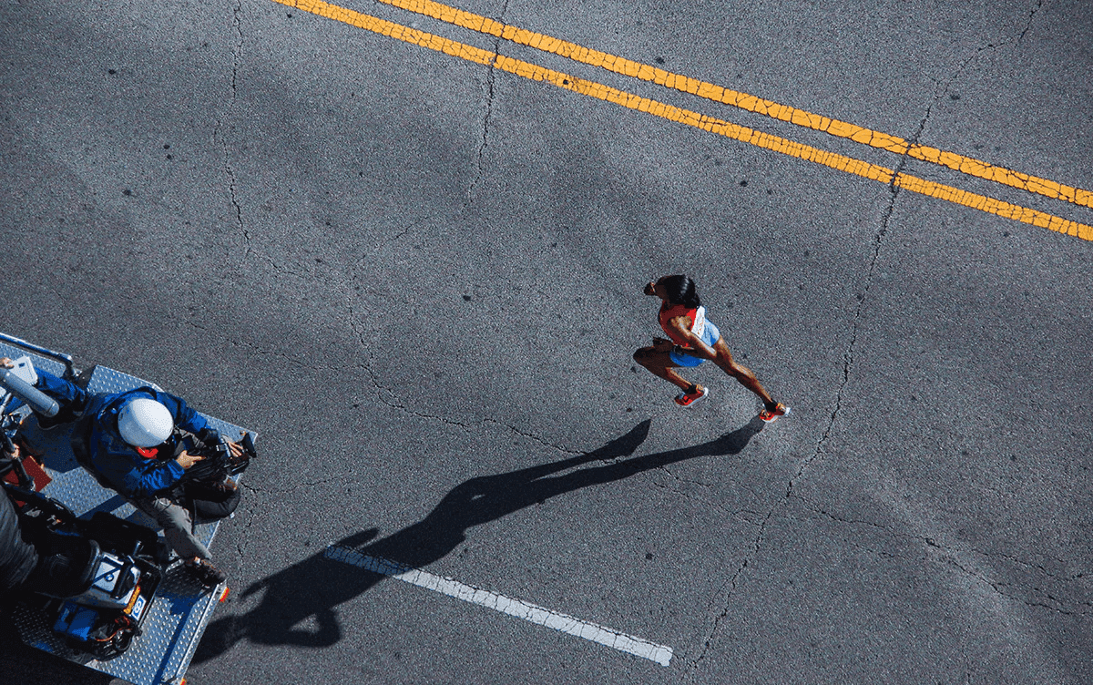 aerial view of a runner training on a road
