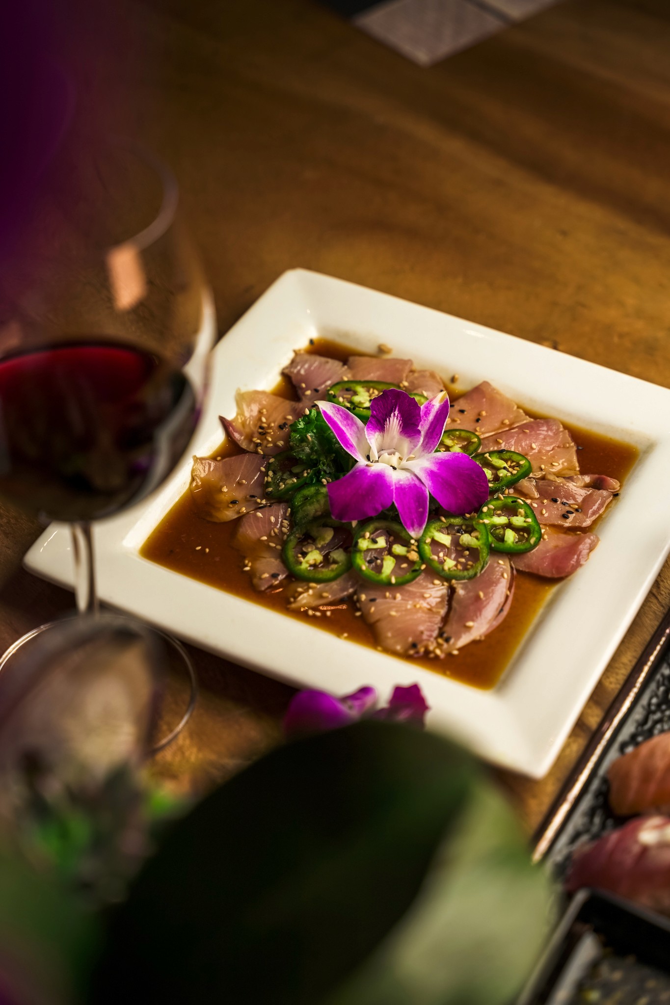 A woman stands in an office, with social media icons emerging from her laptop, symbolizing digital connectivity and engagement.